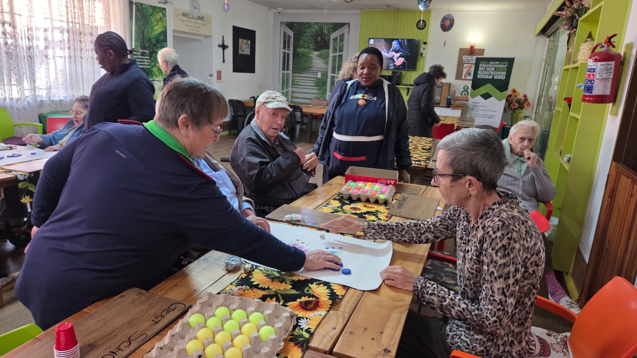 Care group taking part in a social activity around a table