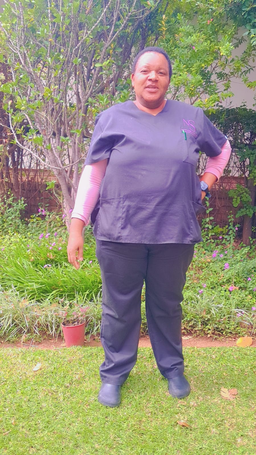 NorthServices Care caregiver standing in a garden
